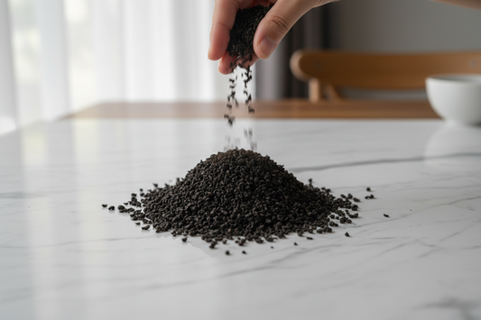 Assam black CTC tea on a white marble surface | Dehing Tea