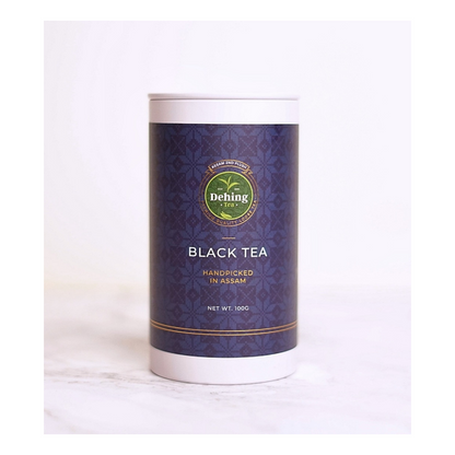 Packaging of Dehing Assam Black Tea, featuring a white and navy tea caddy branded and indicating the product as 'Black Tea' and 'Assam 2nd Flush'.